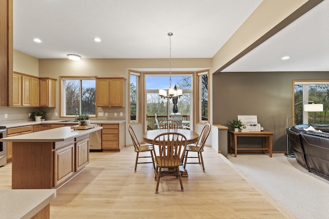 kitchen with light countertops, recessed lighting, light wood-style flooring, and a notable chandelier