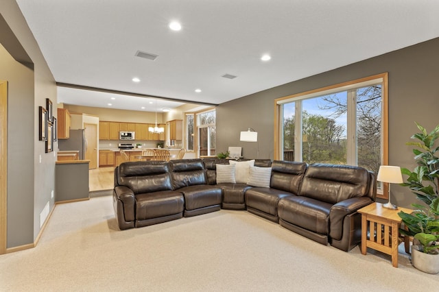 living area with recessed lighting, baseboards, and light carpet