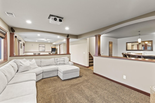 carpeted living room featuring visible vents, recessed lighting, decorative columns, and baseboards