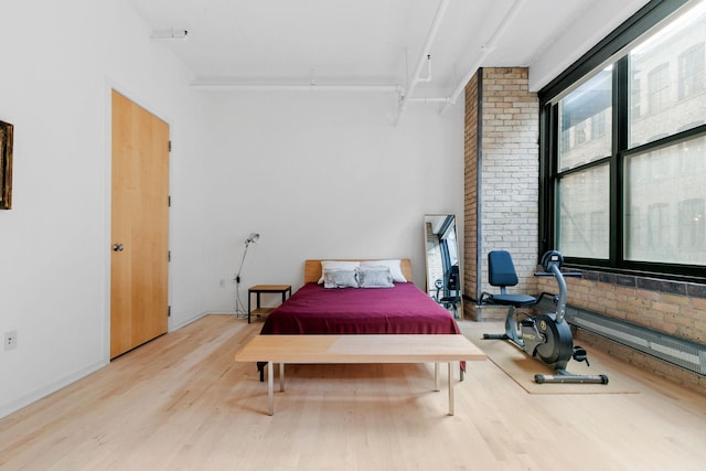 290 Market St Unit 314, Minneapolis, MN 55405 - bedroom with brick wall, wood finished floors, and multiple windows