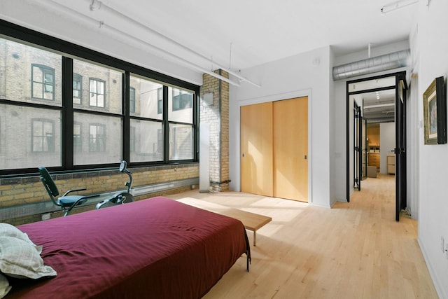 290 Market St Unit 314, Minneapolis, MN 55405 - bedroom with brick wall and light wood-type flooring