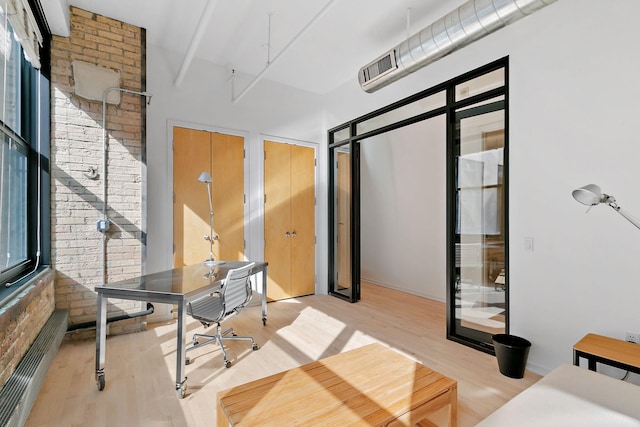 290 Market St Unit 314, Minneapolis, MN 55405 - home office featuring a high ceiling and wood finished floors