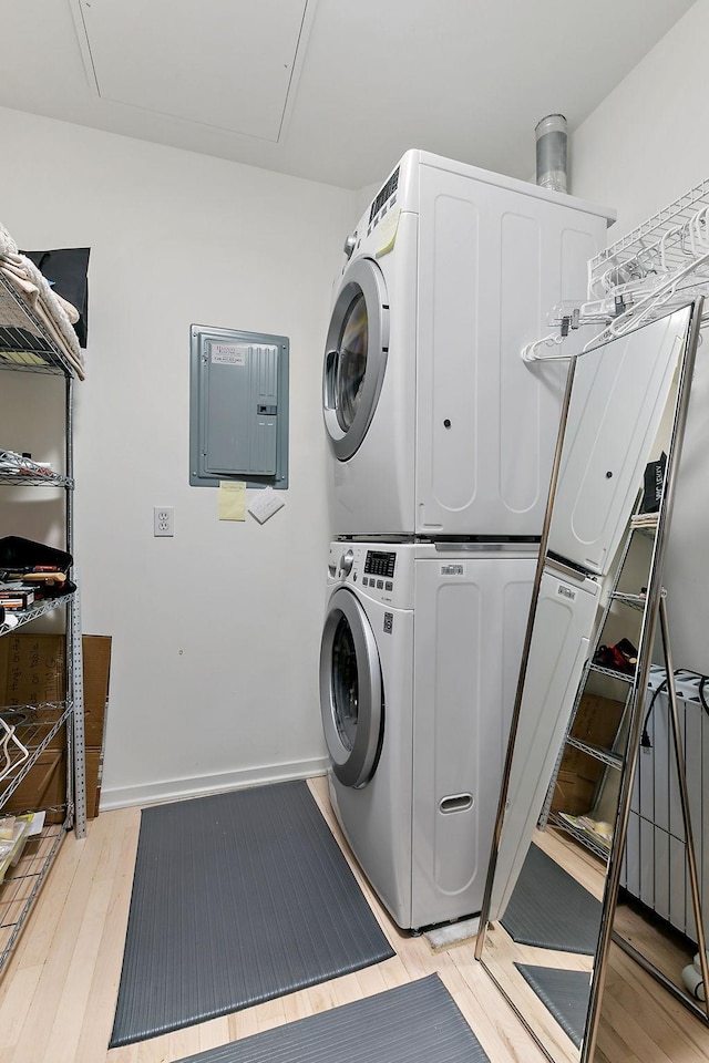 290 Market St Unit 314, Minneapolis, MN 55405 - laundry room featuring stacked washer / drying machine, laundry area, attic access, electric panel, and light wood-style floors