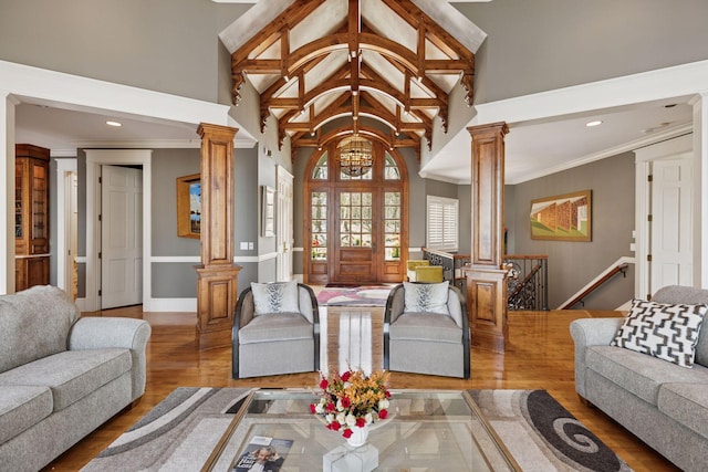 6425 Virginia Dr, Victoria, MN 55331 - living room with ornate columns, wood finished floors, a chandelier, high vaulted ceiling, and recessed lighting