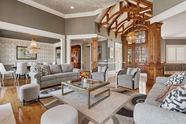 6425 Virginia Dr, Victoria, MN 55331 - living area with a chandelier, decorative columns, light wood finished floors, a wainscoted wall, and high vaulted ceiling