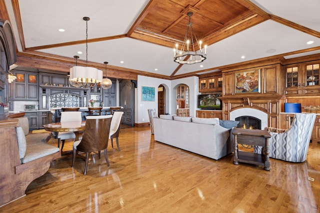 6425 Virginia Dr, Victoria, MN 55331 - living room featuring a chandelier, light wood-style floors, recessed lighting, crown molding, and a lit fireplace