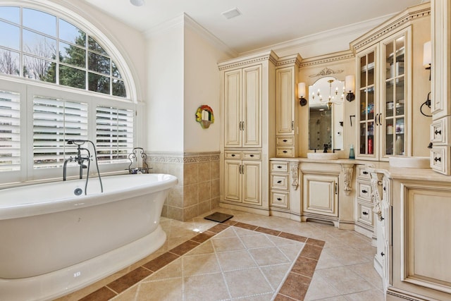 6425 Virginia Dr, Victoria, MN 55331 - bathroom with a freestanding tub, vanity, ornamental molding, a wainscoted wall, and tile patterned floors