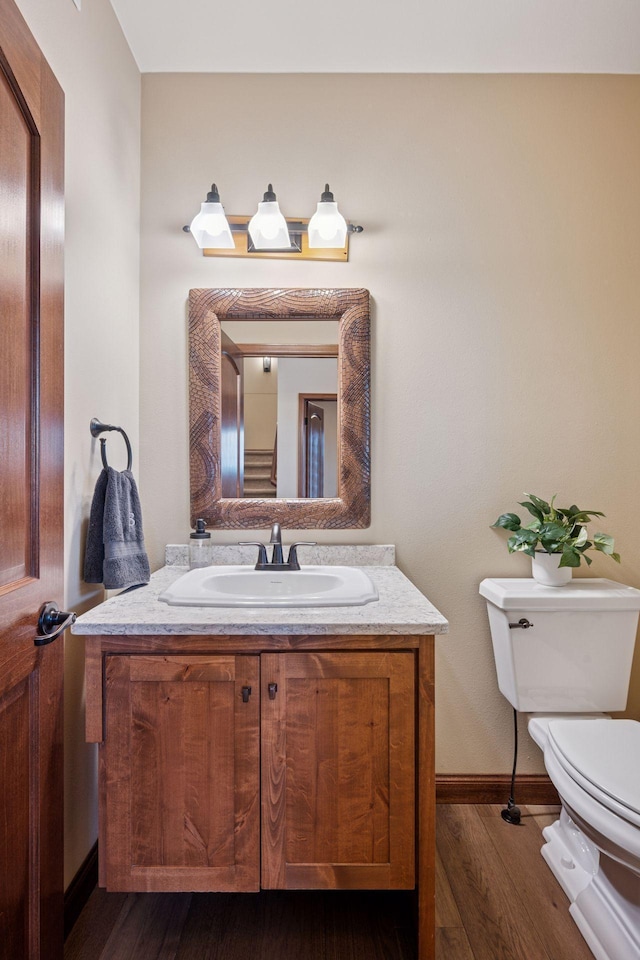 21804 Majestic Dr, Saint Augusta, MN 55320 - half bathroom featuring toilet, baseboards, wood finished floors, and vanity