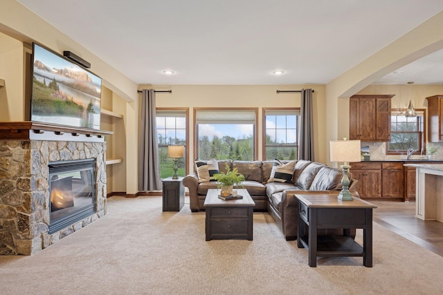 21804 Majestic Dr, Saint Augusta, MN 55320 - living room with arched walkways, a fireplace, recessed lighting, and light carpet