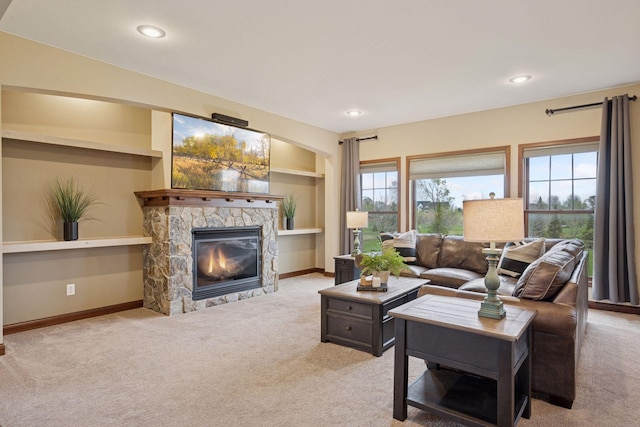 21804 Majestic Dr, Saint Augusta, MN 55320 - living room featuring a stone fireplace, carpet flooring, and a healthy amount of sunlight
