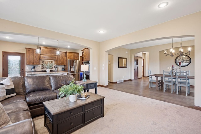 21804 Majestic Dr, Saint Augusta, MN 55320 - living room featuring visible vents, arched walkways, baseboards, carpet, and recessed lighting