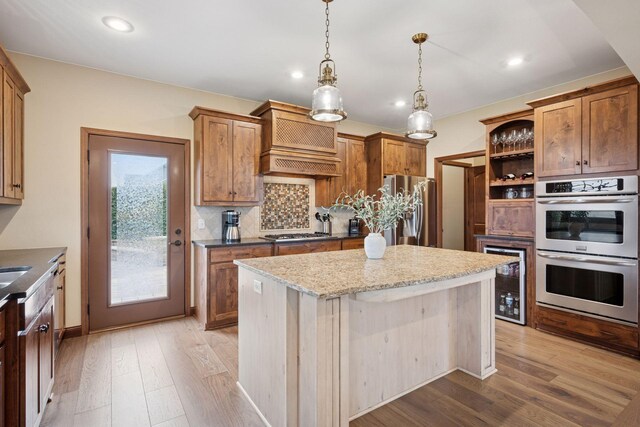 21804 Majestic Dr, Saint Augusta, MN 55320 - kitchen with open shelves, light wood finished floors, premium range hood, a center island, and stainless steel appliances