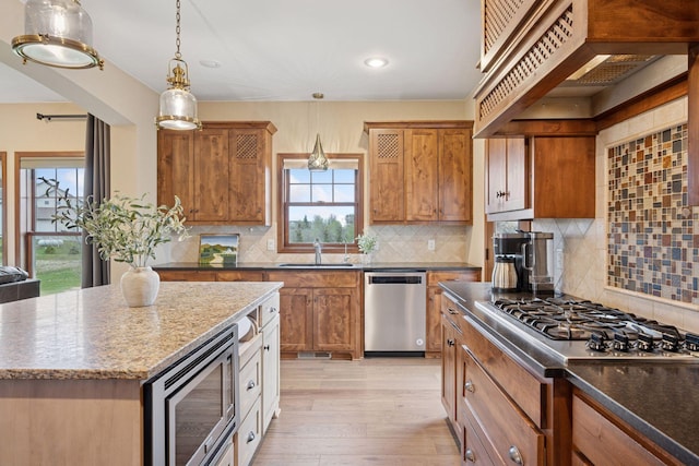21804 Majestic Dr, Saint Augusta, MN 55320 - kitchen with a sink, stainless steel appliances, custom range hood, tasteful backsplash, and pendant lighting