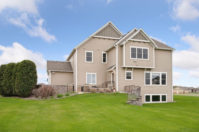 21804 Majestic Dr, Saint Augusta, MN 55320 - back of house with board and batten siding and a yard