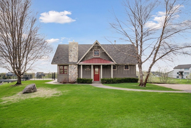 21804 Majestic Dr, Saint Augusta, MN 55320 - tudor house with a front lawn, board and batten siding, fence, and a chimney