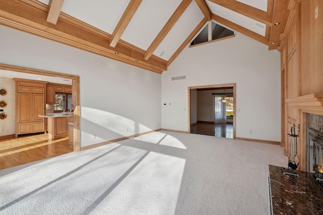 4 Antrim Ter, Edina, MN 55439 - living area with baseboards, beam ceiling, high vaulted ceiling, a high end fireplace, and carpet