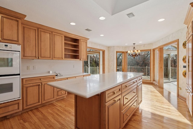 4 Antrim Ter, Edina, MN 55439 - kitchen with a chandelier, light wood-style flooring, light countertops, open shelves, and double oven