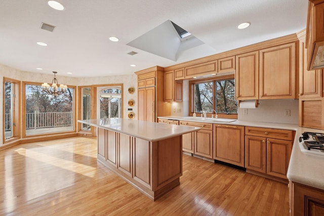 4 Antrim Ter, Edina, MN 55439 - kitchen featuring a sink, light countertops, a notable chandelier, and light wood-style floors