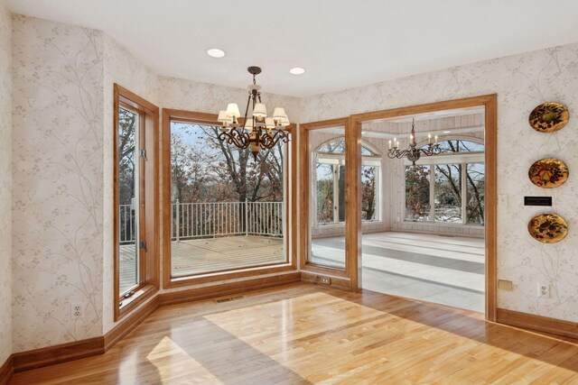 4 Antrim Ter, Edina, MN 55439 - unfurnished dining area featuring baseboards, a notable chandelier, wood finished floors, and wallpapered walls