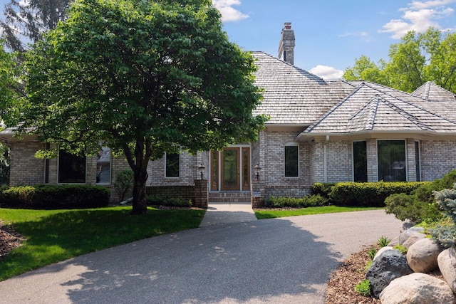 4 Antrim Ter, Edina, MN 55439 - view of front of property featuring a chimney, a front yard, and brick siding