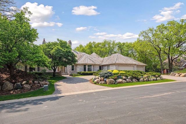 4 Antrim Ter, Edina, MN 55439 - view of front of house with driveway, a chimney, and an attached garage
