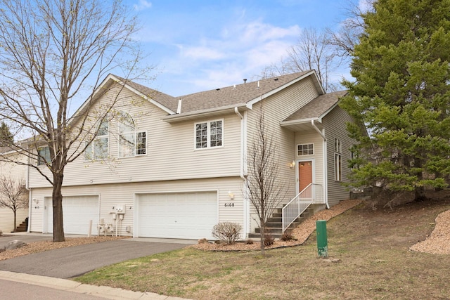 6108 Creek Line Dr, Minnetonka, MN 55345 - view of front facade featuring aphalt driveway, a shingled roof, and an attached garage