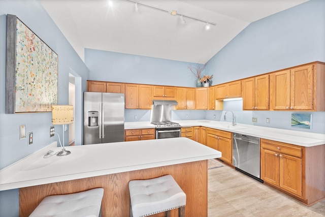 6108 Creek Line Dr, Minnetonka, MN 55345 - kitchen with stainless steel appliances, rail lighting, light countertops, a sink, and a peninsula