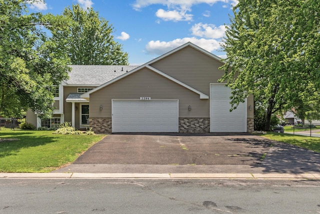 2294 Mathias Rd, Shakopee, MN 55379 - view of front of house with brick siding, an attached garage, asphalt driveway, and a front yard