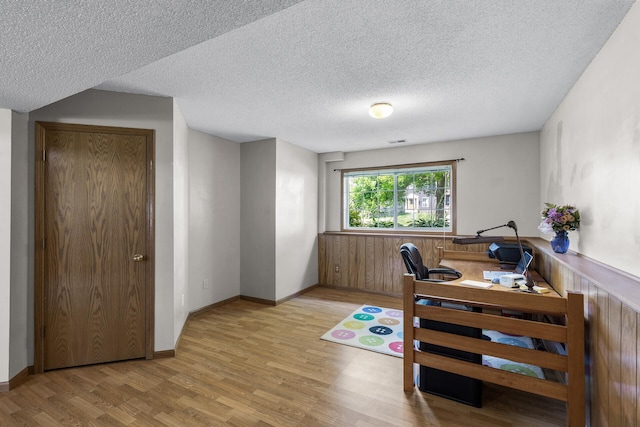 2294 Mathias Rd, Shakopee, MN 55379 - office area with wood finished floors, a textured ceiling, and a wainscoted wall