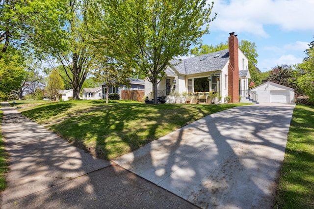 3511 Mckinley St NE, Minneapolis, MN 55418 - bungalow featuring an outdoor structure, a front yard, a chimney, and a garage