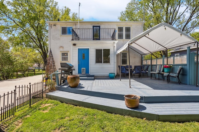 3511 Mckinley St NE, Minneapolis, MN 55418 - rear view of property with fence, a balcony, stucco siding, and a deck