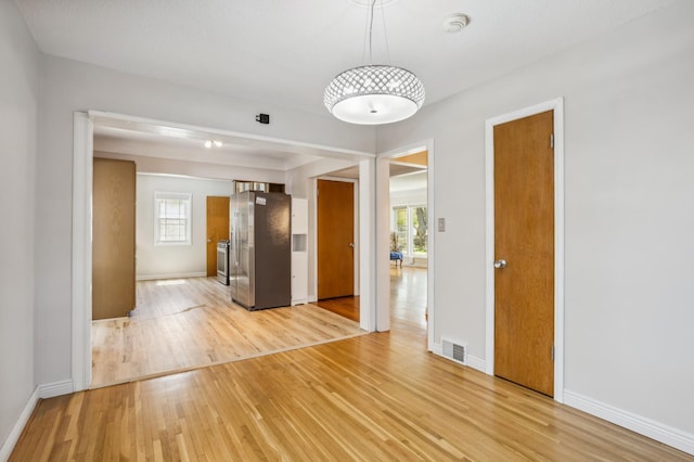 3511 Mckinley St NE, Minneapolis, MN 55418 - spare room with light wood-style floors, healthy amount of natural light, and baseboards