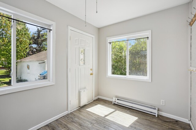 3511 Mckinley St NE, Minneapolis, MN 55418 - foyer entrance featuring a baseboard radiator, healthy amount of natural light, and baseboards
