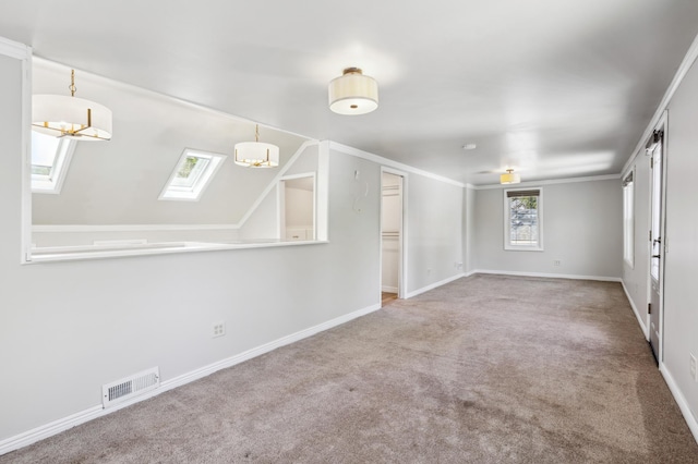 3511 Mckinley St NE, Minneapolis, MN 55418 - carpeted spare room with baseboards, a skylight, and a chandelier