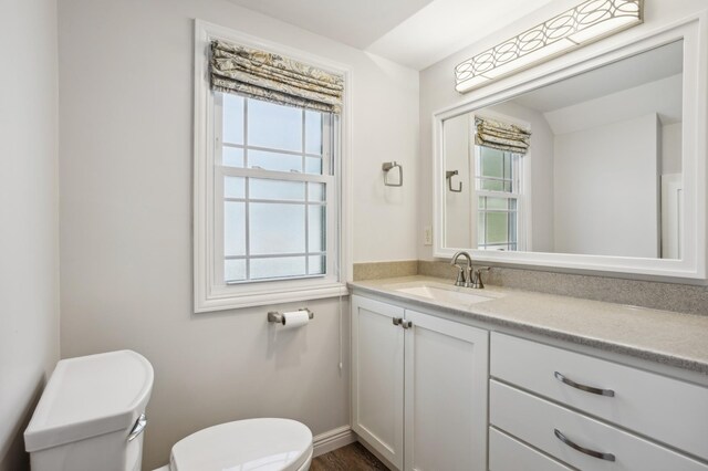 3511 Mckinley St NE, Minneapolis, MN 55418 - half bath featuring toilet, vanity, and baseboards