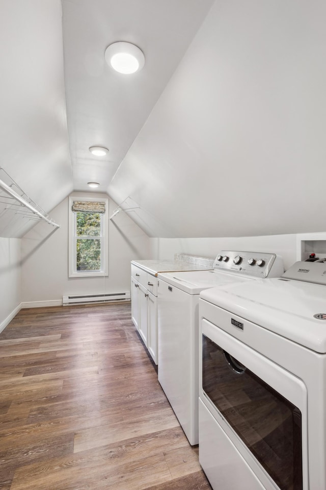 3511 Mckinley St NE, Minneapolis, MN 55418 - laundry room featuring independent washer and dryer, a baseboard radiator, light wood-style flooring, and cabinet space