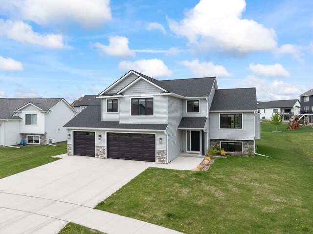 1764 Brandt Dr NE, Byron, MN 55920 - view of front of house with concrete driveway, a front yard, stone siding, and roof with shingles