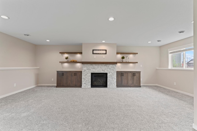 1764 Brandt Dr NE, Byron, MN 55920 - unfurnished living room featuring carpet flooring, baseboards, recessed lighting, and a glass covered fireplace