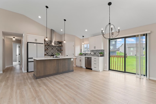 1764 Brandt Dr NE, Byron, MN 55920 - kitchen featuring wall chimney exhaust hood, freestanding refrigerator, stainless steel dishwasher, tasteful backsplash, and white cabinetry