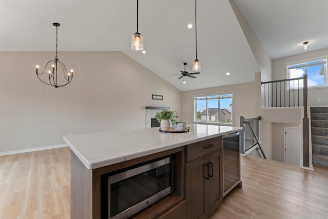 1764 Brandt Dr NE, Byron, MN 55920 - kitchen featuring beverage cooler, stainless steel microwave, lofted ceiling, healthy amount of natural light, and a chandelier