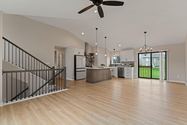 1764 Brandt Dr NE, Byron, MN 55920 - kitchen with freestanding refrigerator, stainless steel dishwasher, a center island, white cabinets, and lofted ceiling