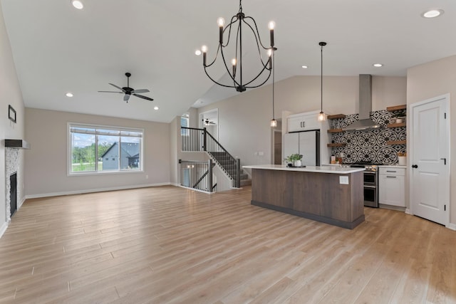 1764 Brandt Dr NE, Byron, MN 55920 - kitchen with freestanding refrigerator, wall chimney exhaust hood, a ceiling fan, light countertops, and lofted ceiling