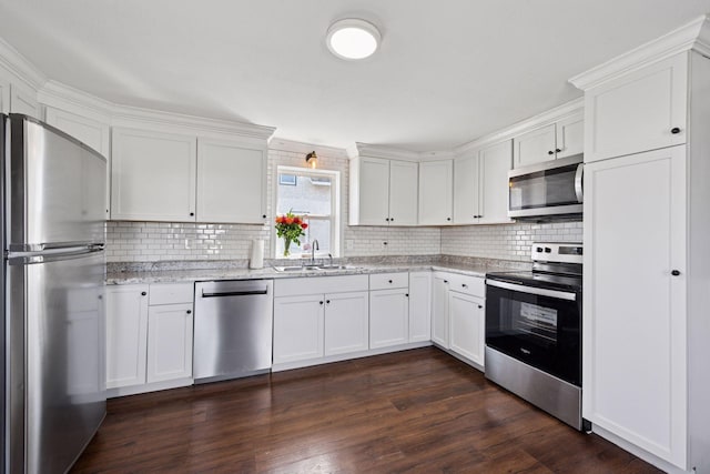 538 Jackson Ave NW, Elk River, MN 55330 - kitchen with stainless steel appliances, a sink, white cabinetry, and tasteful backsplash