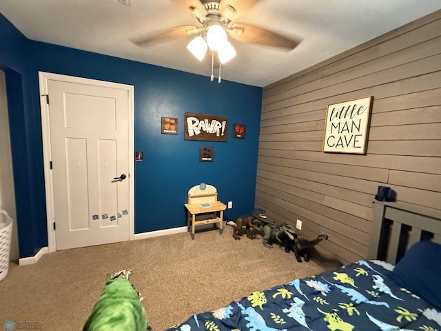 436 2nd Ave E, Halstad, MN 56548 - bedroom featuring carpet floors, wooden walls, baseboards, and ceiling fan