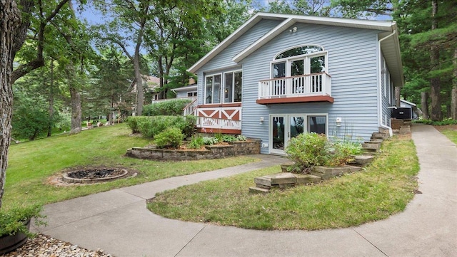 back of property with a wooden deck and a yard