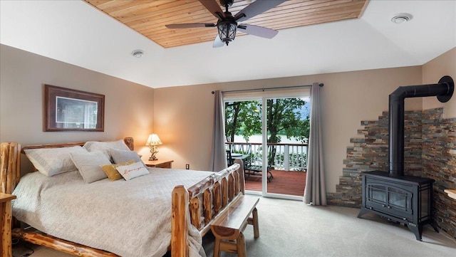 bedroom with wood ceiling, a wood stove, light colored carpet, access to outside, and visible vents