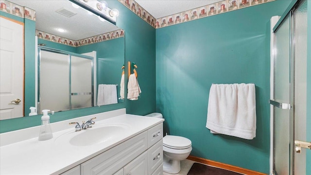 bathroom with a textured ceiling, a stall shower, vanity, toilet, and visible vents