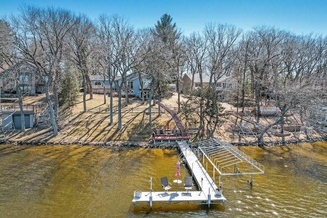 dock area featuring stairway and a water view