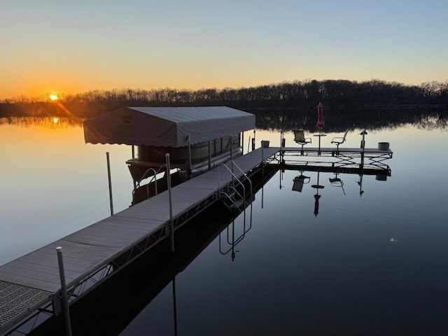view of dock with boat lift and a water view