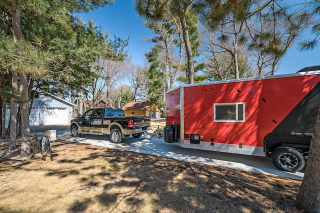 view of property exterior featuring an outdoor structure and a detached garage